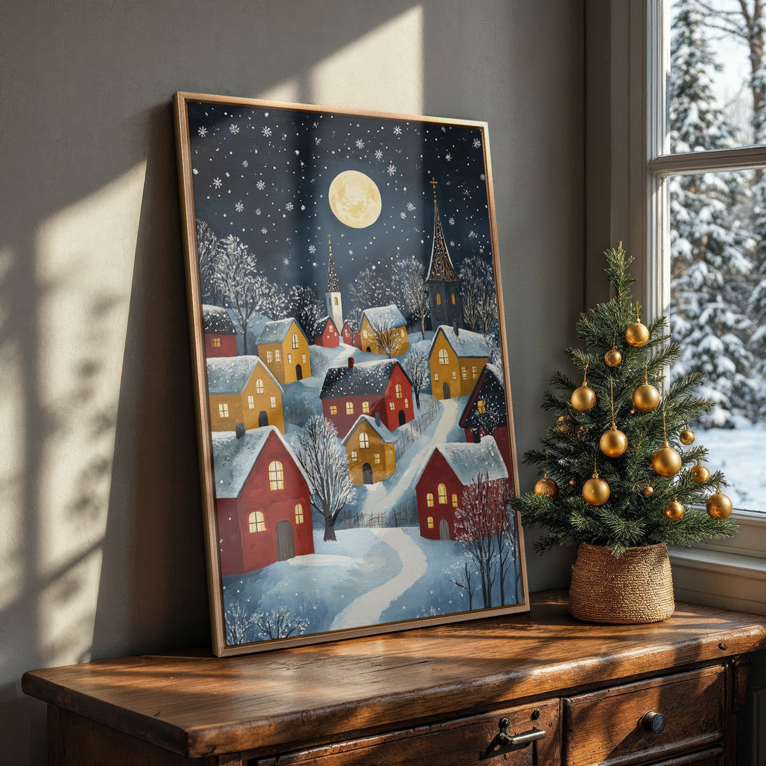 Framed Wall Art: Winter village scene Canvas Print in a cozy interior. Features a whimsical style with a blue, red, and yellow color palette. Perfect holiday decor.