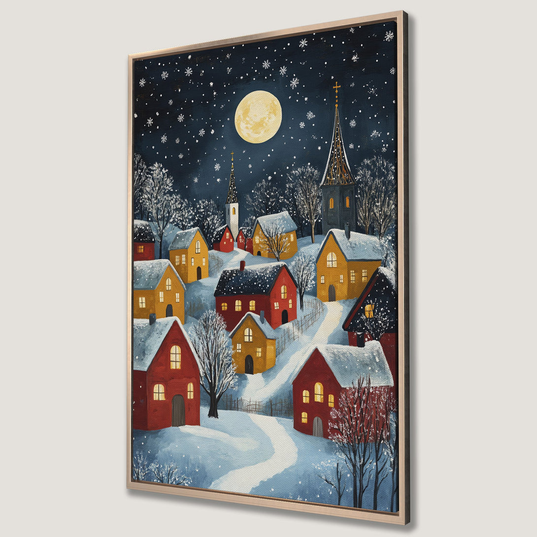 Framed Wall Art: Winter village scene with red & yellow houses under a moonlit night sky. Cozy art print with a charming, whimsical style and a blue & warm color palette.