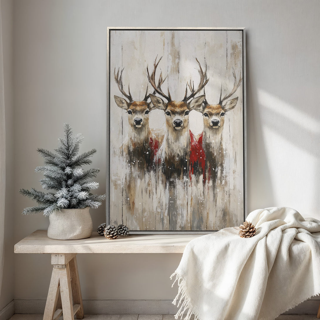 Framed Wall Art featuring three deer in a rustic style with a neutral and red color palette, perfect for adding warmth to your home decor.