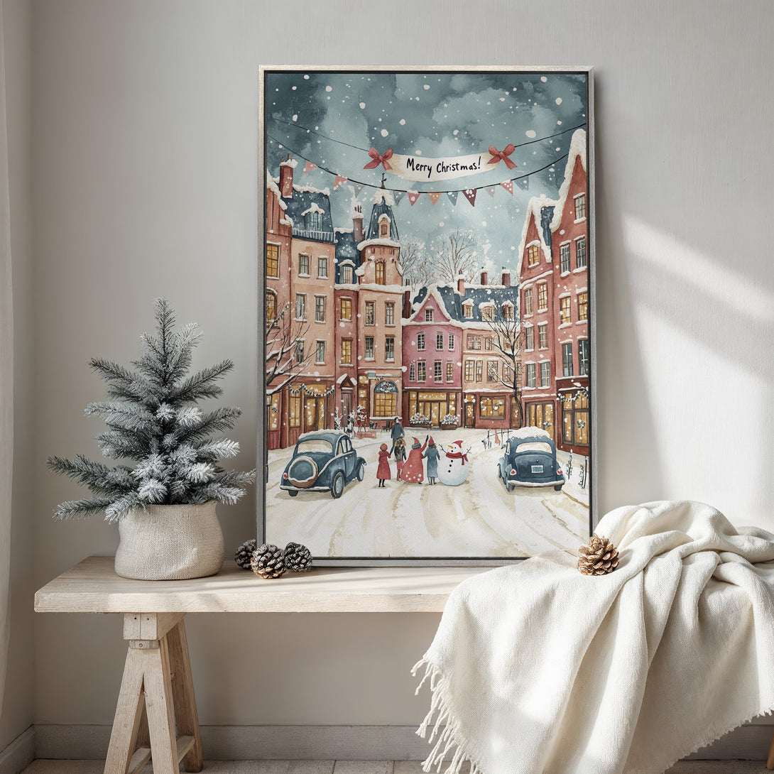 Framed Wall Art: Watercolor Christmas scene of a snowy European town. Warm, inviting color palette with pink, red, and blue hues. Perfect holiday decor.