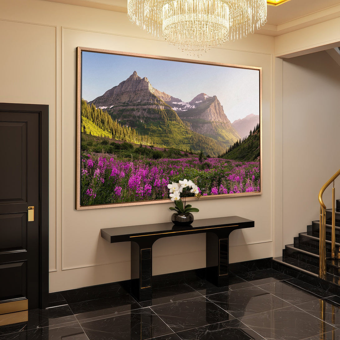 Framed Wall Art: Mountain landscape canvas print in a luxury interior. Featuring vibrant purple flowers, green trees, and a blue sky. Earthy tones.