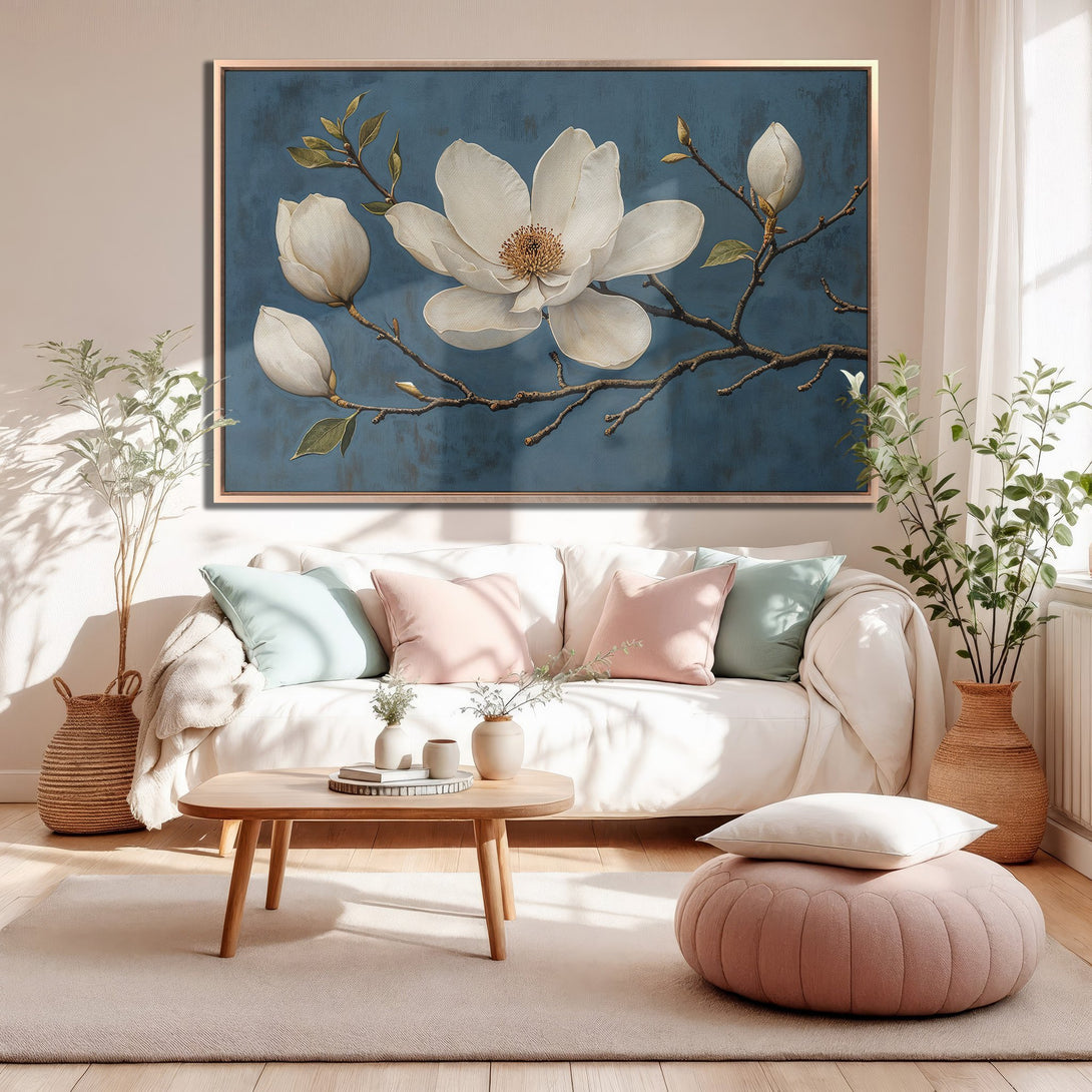 Framed Wall Art: Elegant magnolia canvas print in a modern living room. Features a blue background and a soft, neutral color palette.