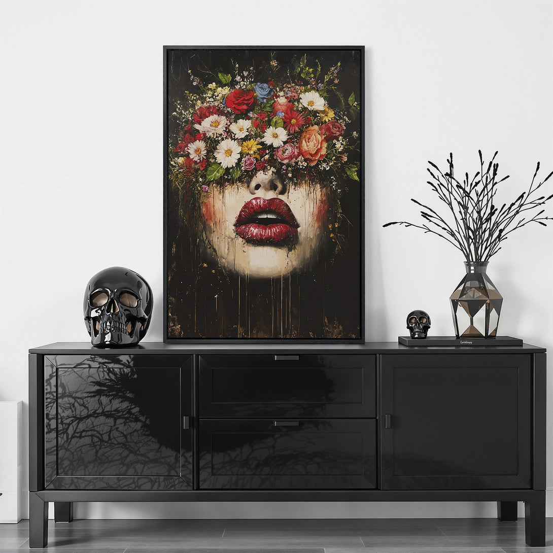 Framed Wall Art featuring a woman's face with floral crown and red lips. Dark, moody style with a vibrant, colorful palette. Perfect for modern decor.