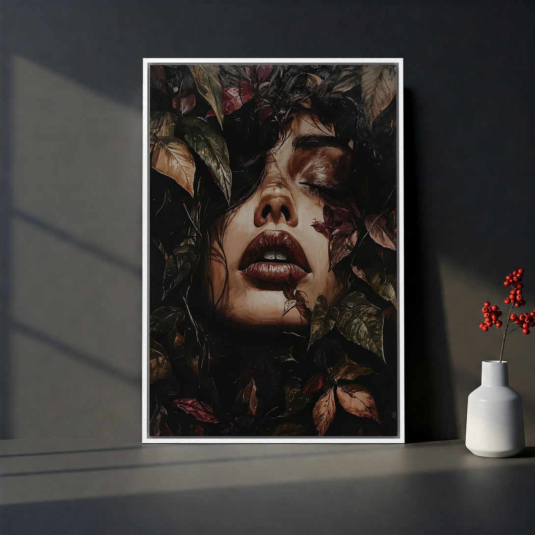 Framed Wall Art featuring a woman's face surrounded by leaves, in a moody, dark color palette. Perfect for adding a touch of elegance to any space.