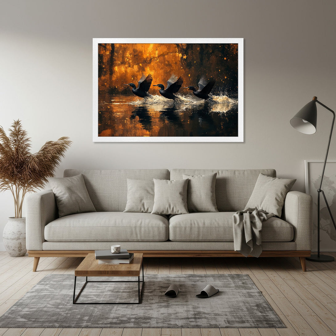 Framed Poster of cormorants taking flight. Artistic style with warm orange, black, and gold tones. Perfect wall art for your home.