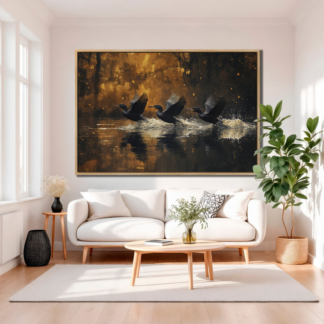 Framed Wall Art featuring black birds taking flight over water, in a modern, abstract style with a warm, golden color palette. Perfect for home decor!
