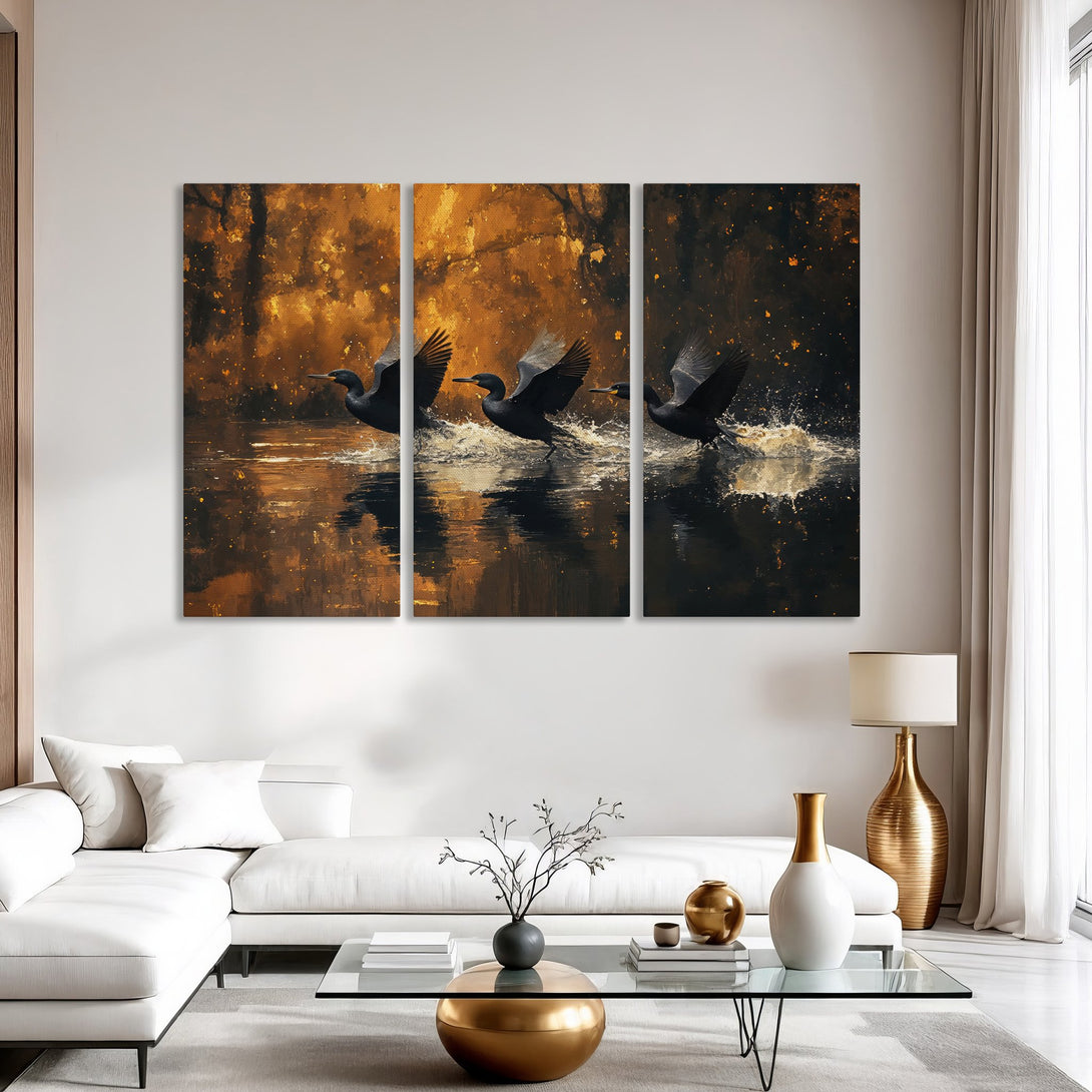 Canvas Print of birds taking flight over water, abstract style, warm gold and black color palette, perfect for modern decor.