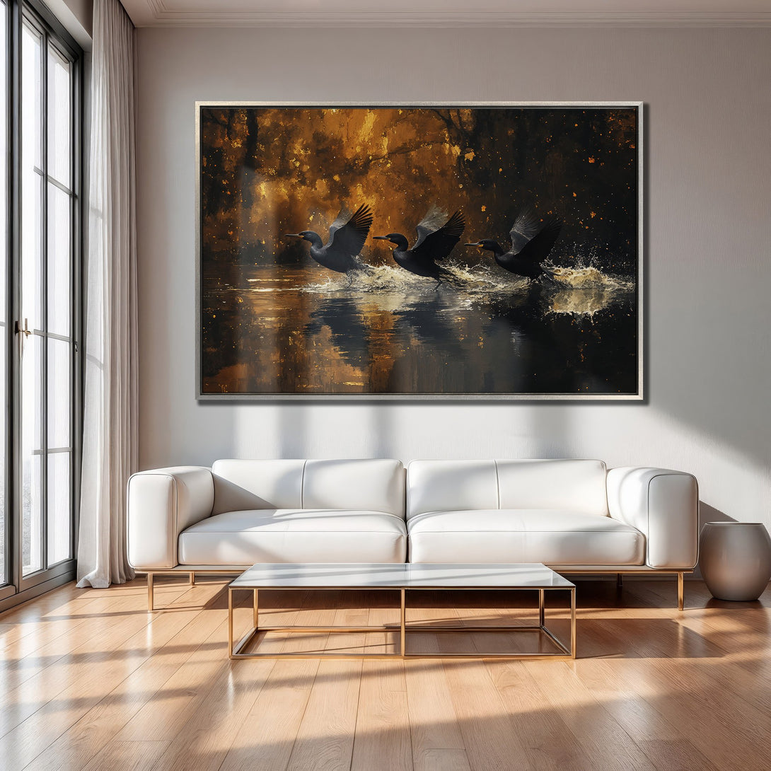 Framed Wall Art: Dramatic painting of birds taking flight over water, with a warm gold and black color palette, perfect for modern living rooms.
