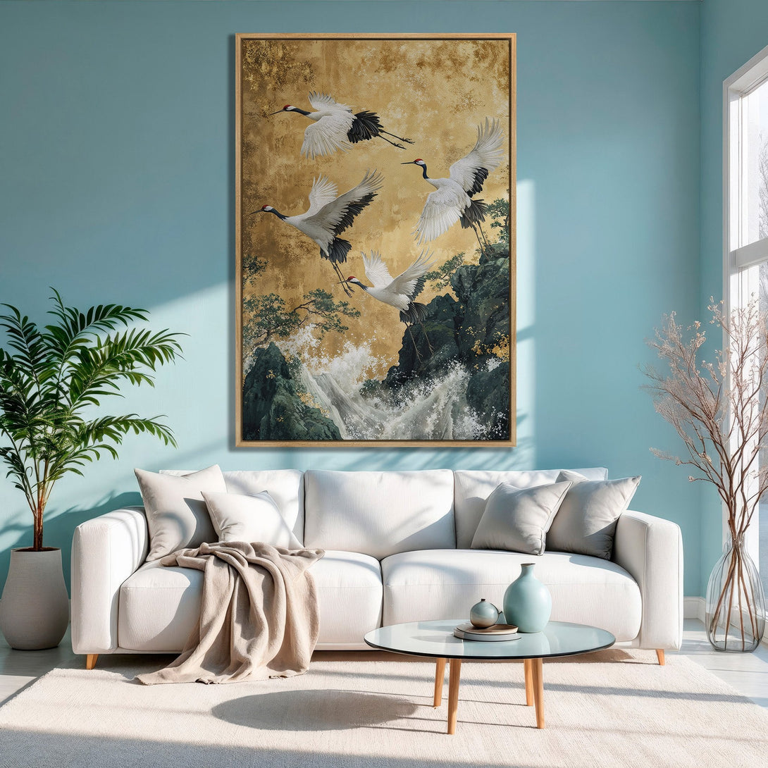 Framed Wall Art featuring elegant cranes in flight, displayed in a modern living room. Gold, black, and white color palette, perfect for adding a touch of zen.