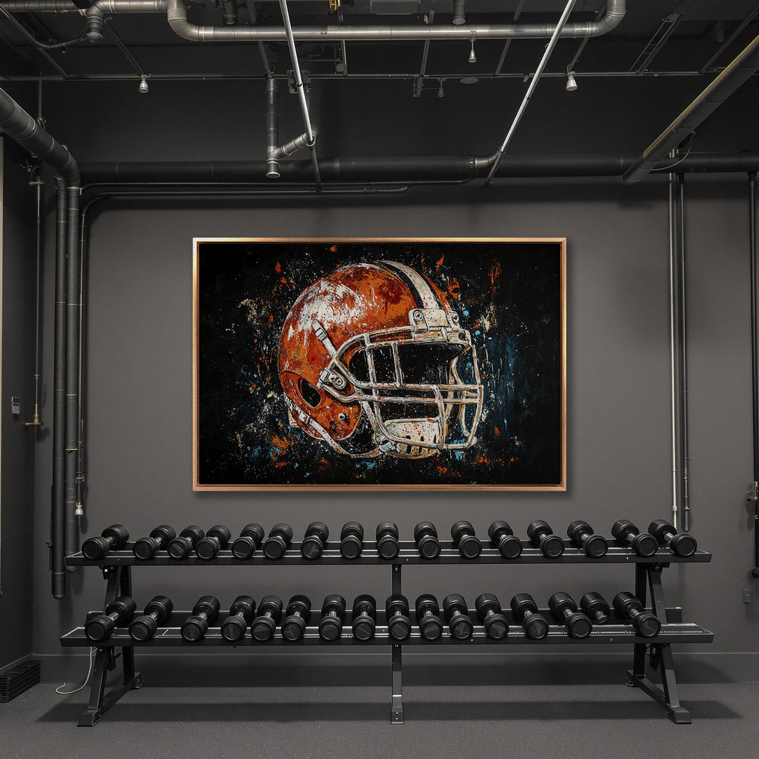 Framed Wall Art featuring a football helmet in an abstract style, orange, black, and blue color palette. Perfect for gym or sports decor.
