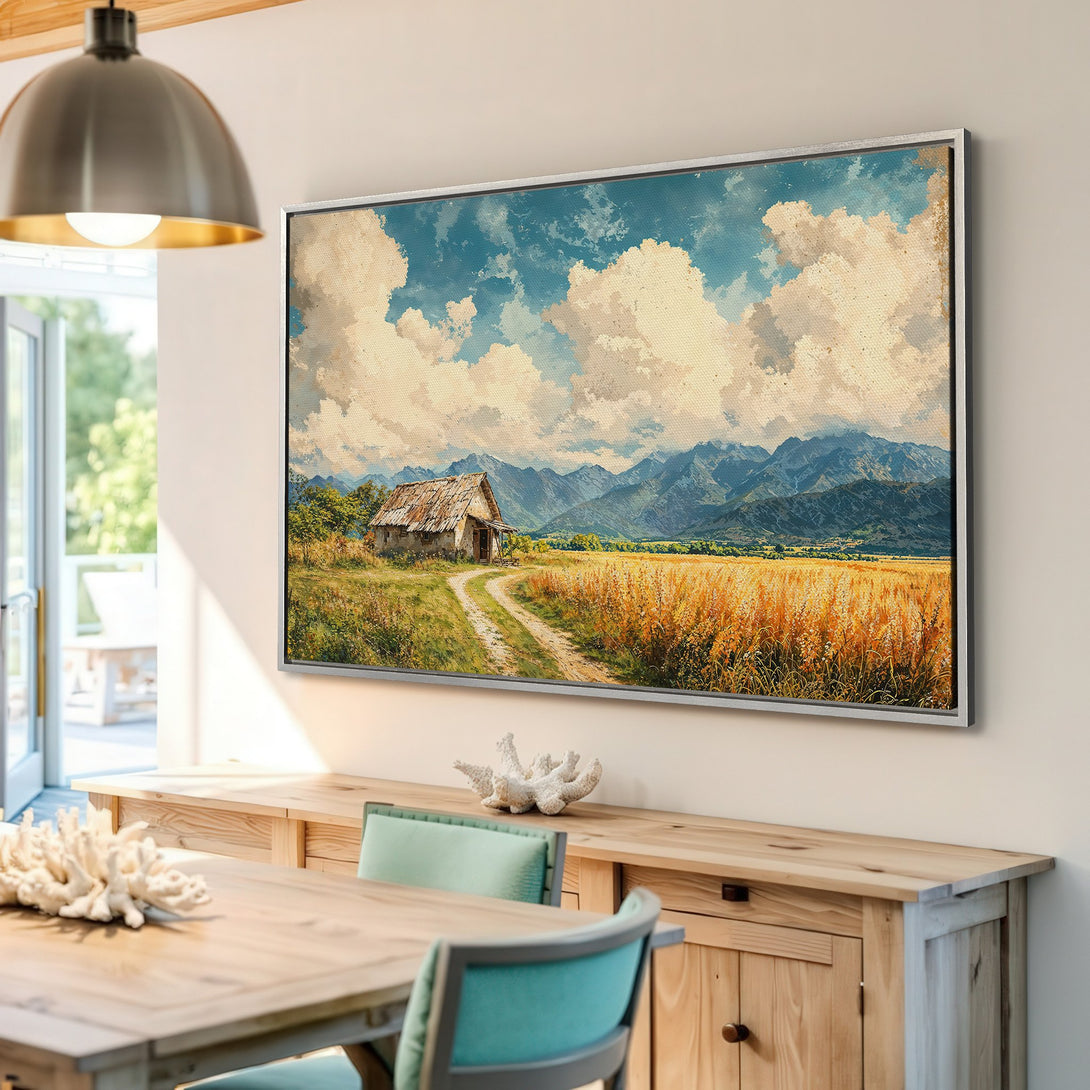 Framed Wall Art: Rustic landscape Canvas Print with a farmhouse, mountains, and wheat field in warm, inviting colors. Perfect for adding a cozy touch.