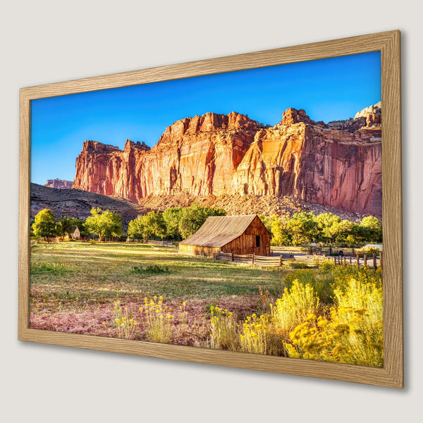 Framed Poster featuring a scenic landscape with red rock cliffs, a barn, and a vibrant color palette. Perfect wall art!