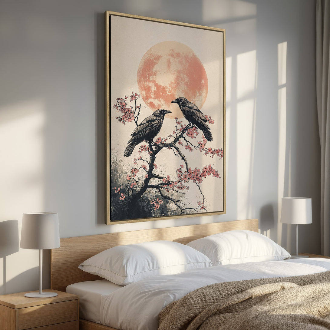 Framed Wall Art: Japanese-inspired canvas print featuring crows on a flowering branch, with a peach moon backdrop. Neutral tones and a touch of pink. Perfect bedroom decor!