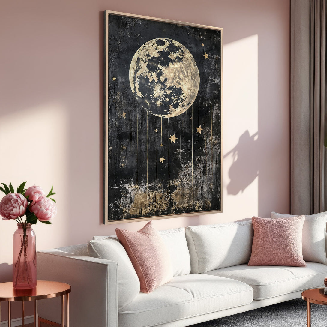 Framed Wall Art: Abstract moon and stars canvas print in a modern living room. Black, gold, and blush pink color palette. Elevate your space!