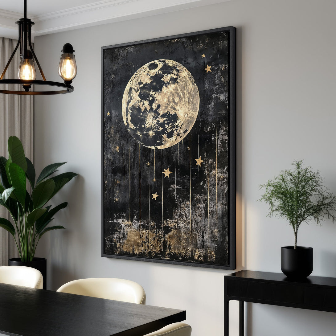 Framed Wall Art featuring a celestial moon and stars design in a modern, abstract style. The canvas print boasts a striking black and gold color palette, perfect for any interior.