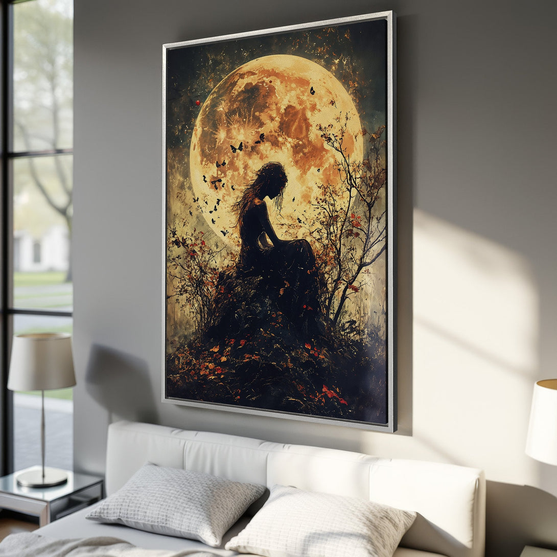 Framed Wall Art: Silhouette of a woman under a golden moon. Dark, moody art with warm orange, black and brown tones. Perfect for bedroom decor.