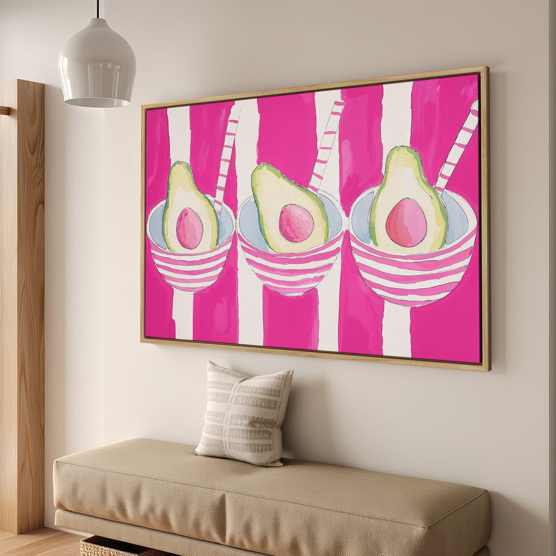 Framed Wall Art featuring a vibrant avocado print with a pink and white striped background. Modern, colorful art for your home.