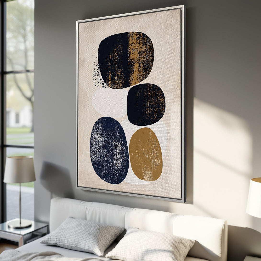 Framed Wall Art featuring abstract geometric shapes in navy, gold, and white on a neutral canvas. Modern art for your home decor.