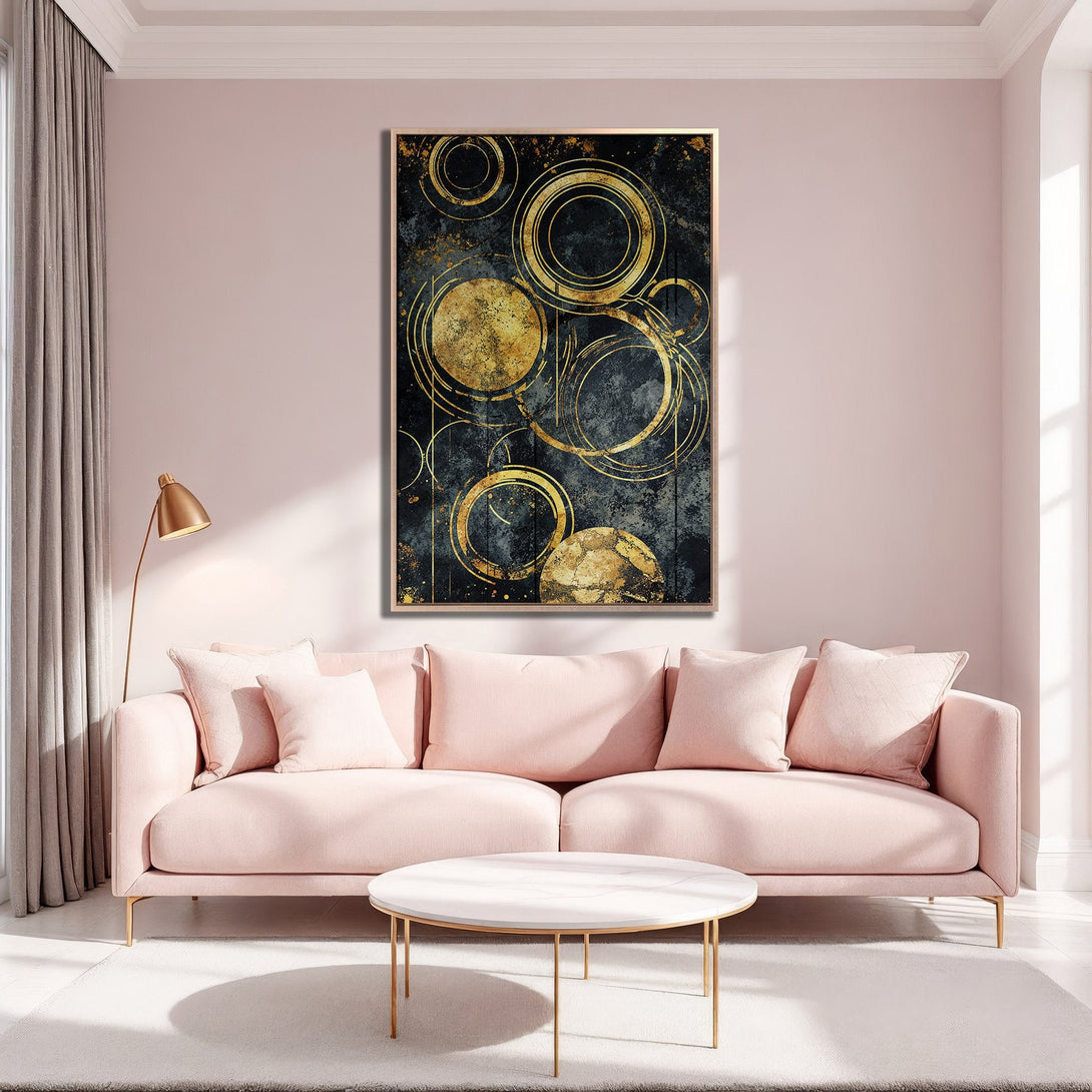 Framed Wall Art featuring abstract gold circles on a dark background, displayed in a modern interior with a soft pink and gold color palette.