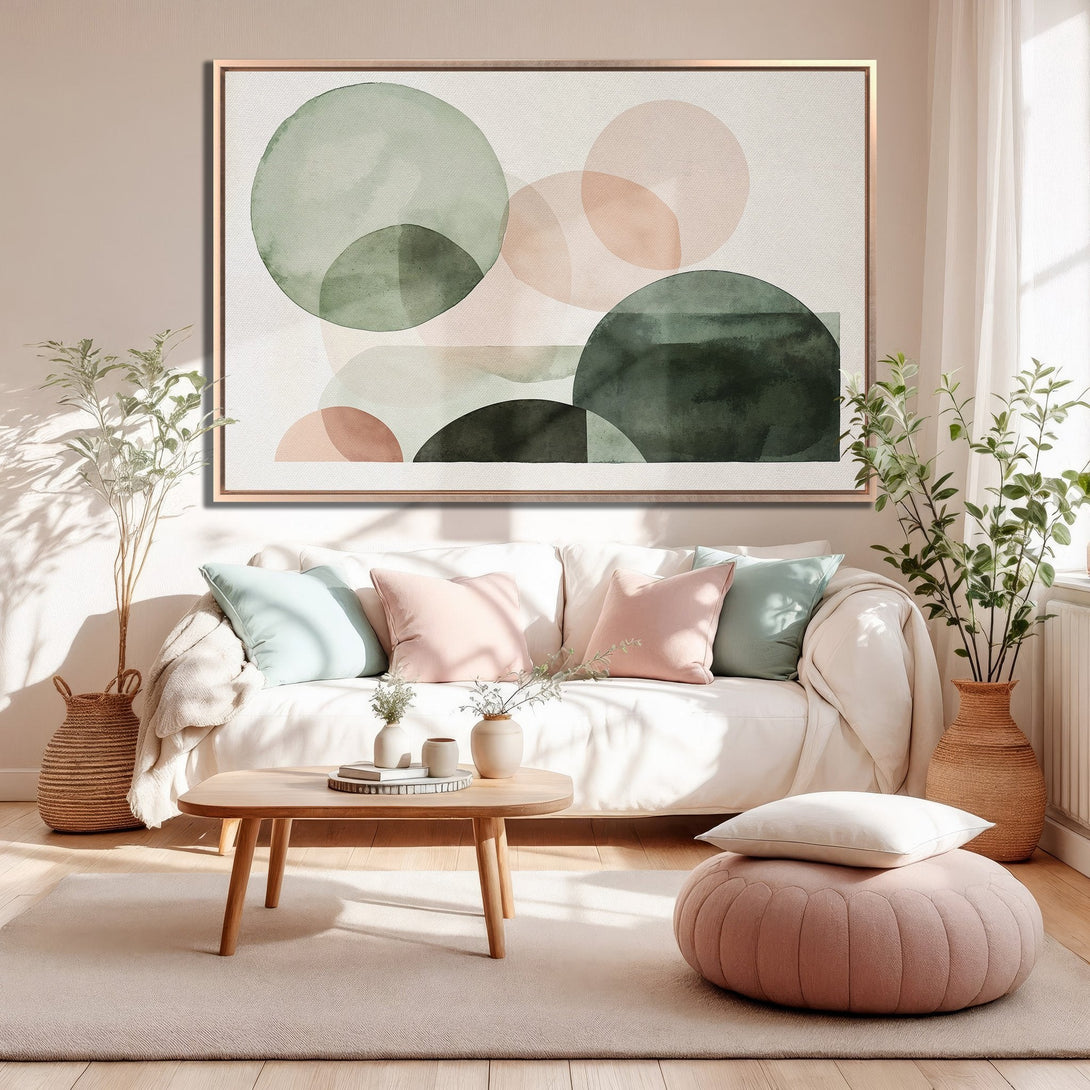 Framed Wall Art featuring abstract watercolor circles in green and blush tones, displayed in a modern living room. Perfect for adding a touch of elegance.