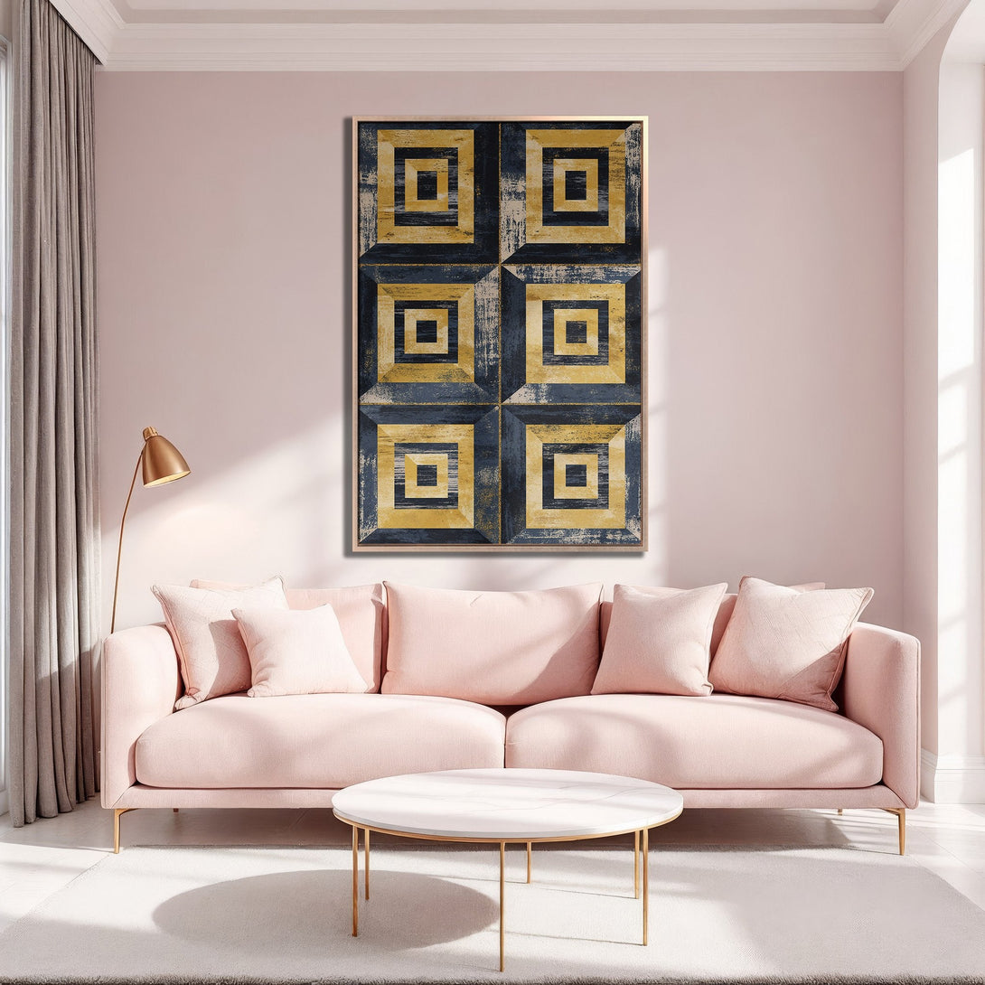 Framed Wall Art featuring a geometric abstract design in navy and gold, displayed above a pink sofa in a modern interior.