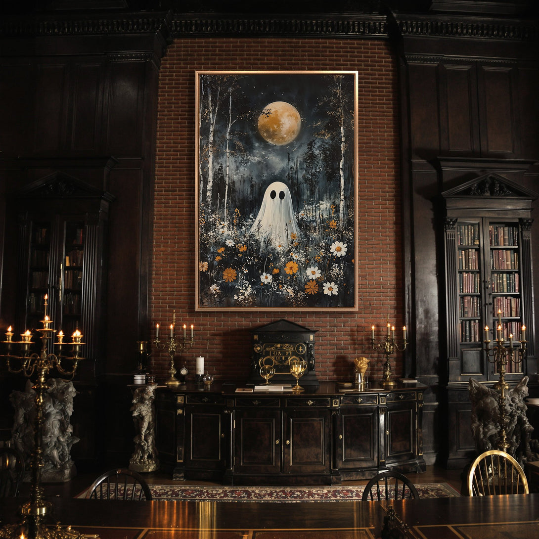 Framed Wall Art featuring a whimsical ghost painting in a moody, dark interior. The artwork has a dark, cool color palette with pops of white and orange.