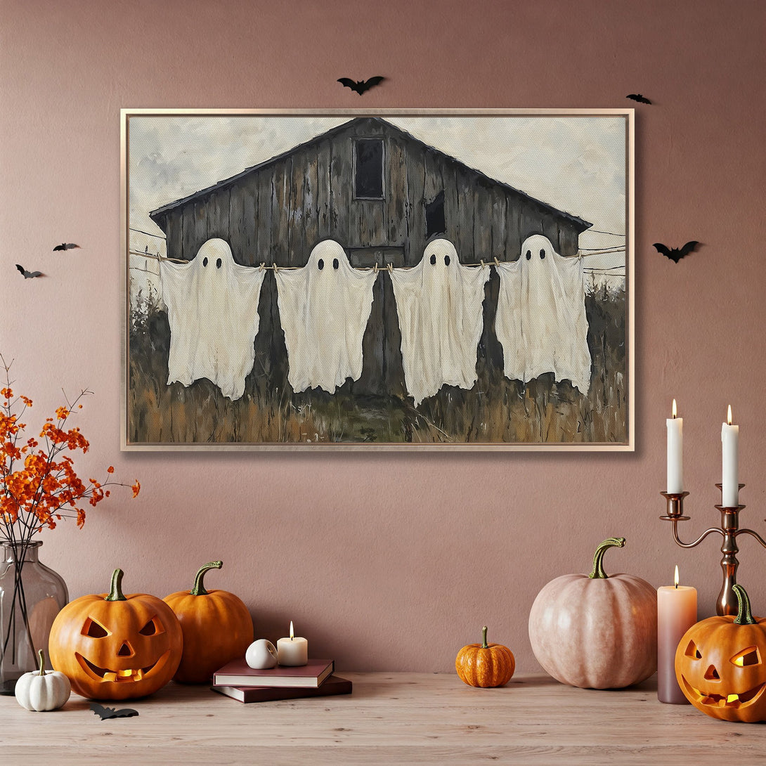 Framed Wall Art featuring whimsical ghosts hanging on a line, rustic style, with a neutral and warm color palette, perfect for Halloween decor.