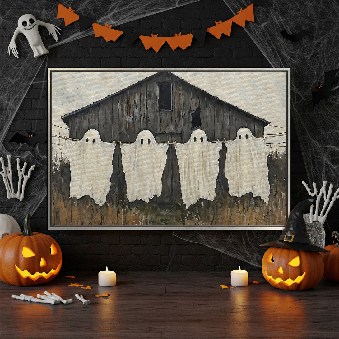 Framed Wall Art featuring a spooky painting of ghosts on a clothesline. Rustic style, neutral & orange color palette. Perfect Halloween decor!