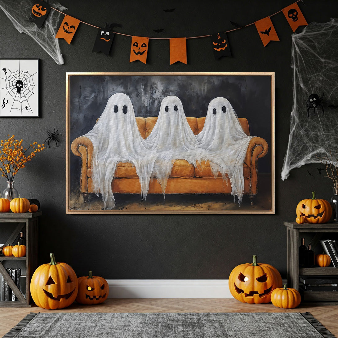 Framed Wall Art featuring whimsical ghosts on a couch, perfect for Halloween decor. Warm orange and black color palette. Add spooky style to your space!