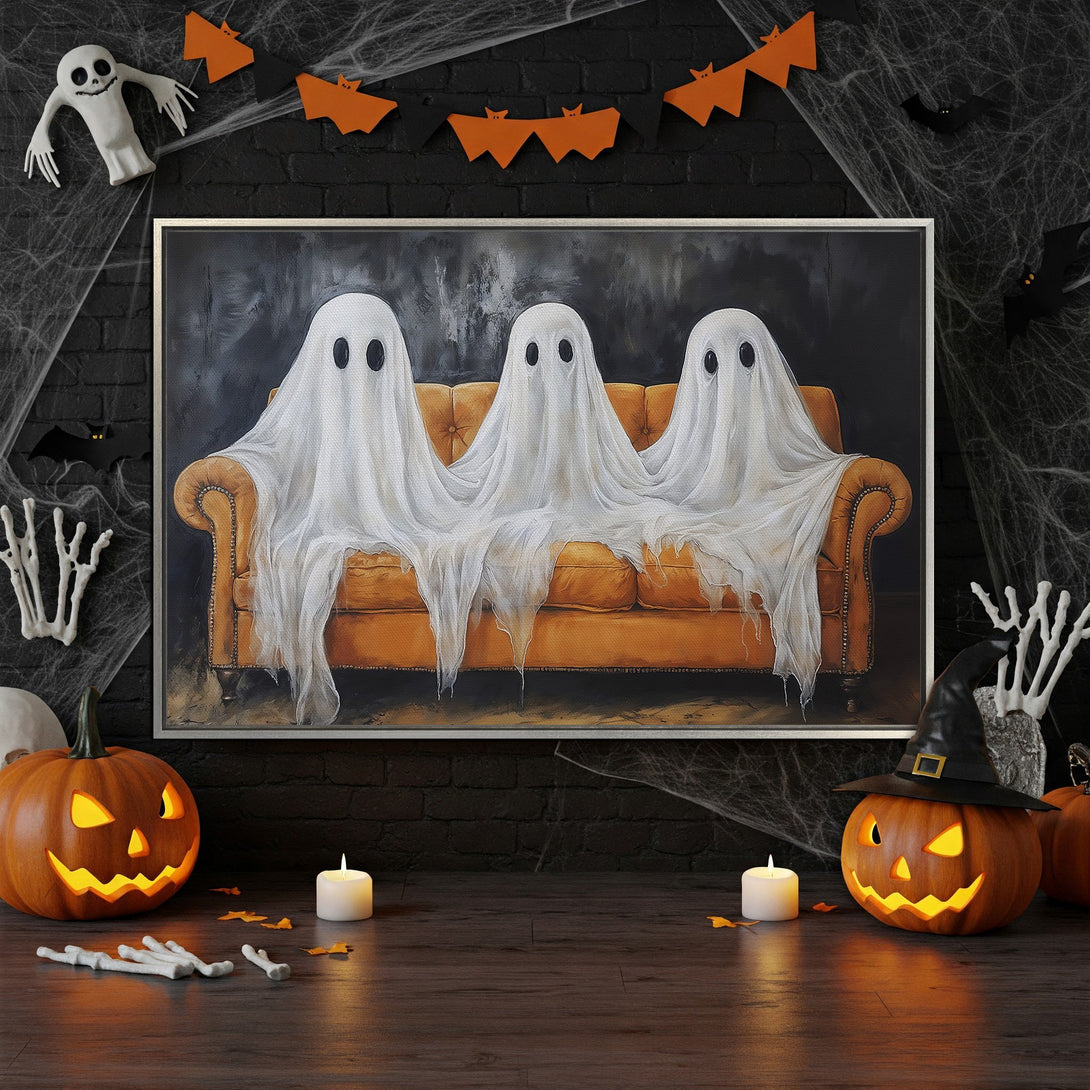 Framed Wall Art: Spooky Halloween canvas print featuring three ghosts on an orange couch. Dark, moody color palette with orange and white accents. Perfect for Halloween decor!