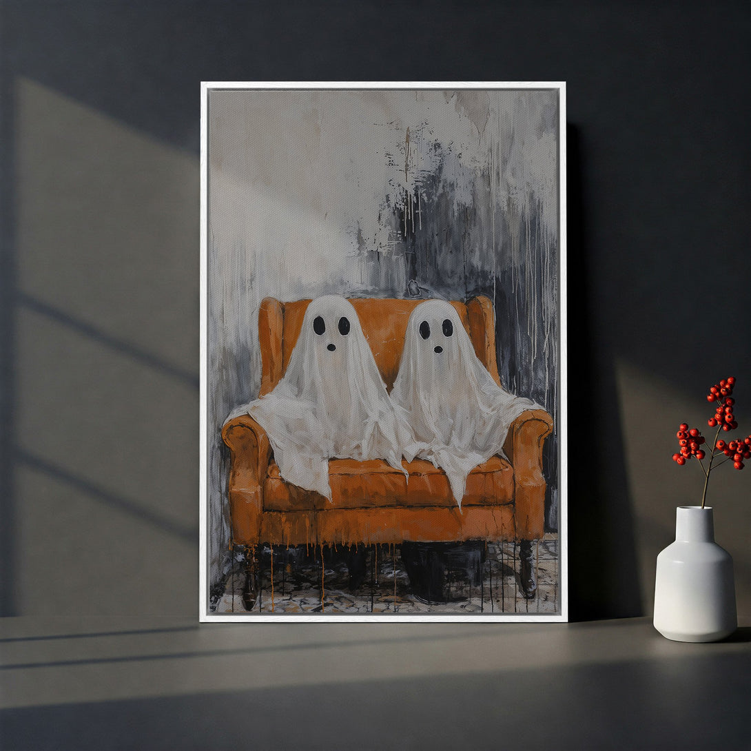 Framed Wall Art featuring two friendly ghosts on an orange couch. Abstract style with a gray and white background. Perfect Halloween decor!