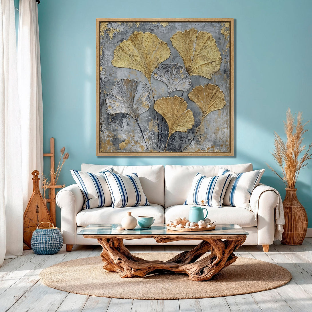 Framed Wall Art featuring gold ginkgo leaves on a textured gray background. Coastal-inspired decor with a calming blue and neutral color palette. Elevate your space!