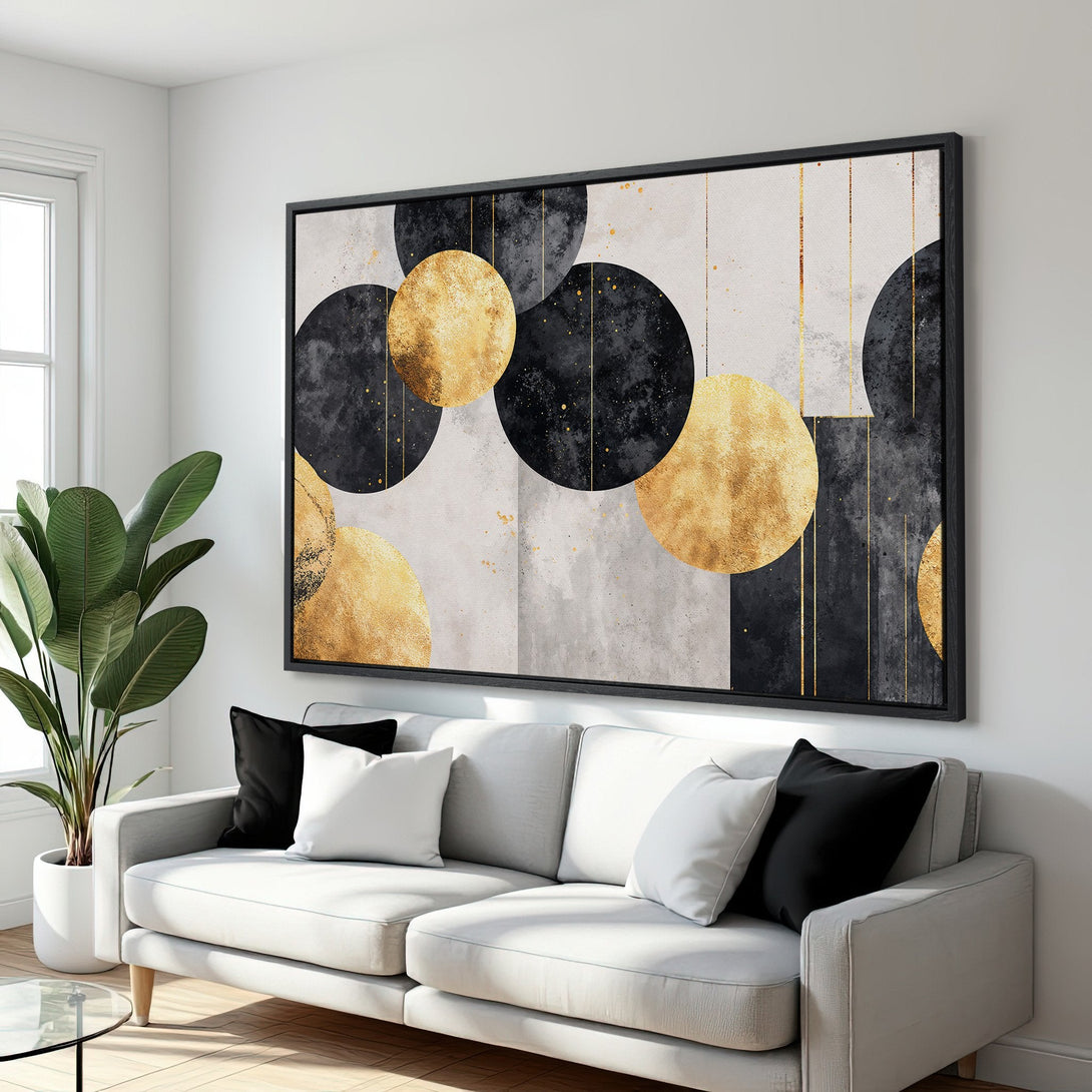 Framed Wall Art featuring abstract gold and black circles. Modern art canvas print with a neutral and luxurious color palette.