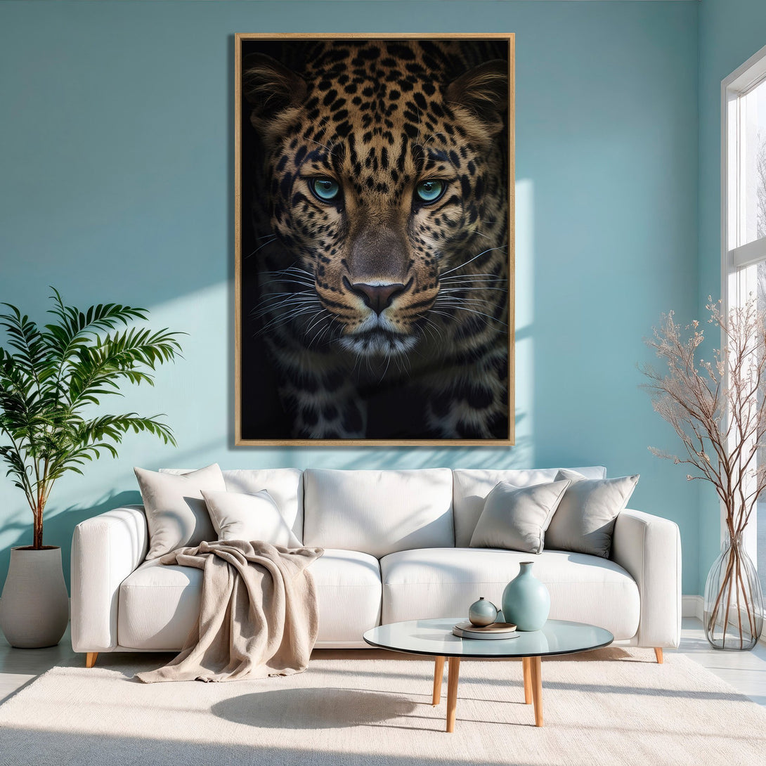 Framed Wall Art: Stunning leopard portrait with piercing blue eyes. Earthy tones against a modern teal interior. Elevate your space with this captivating canvas print.