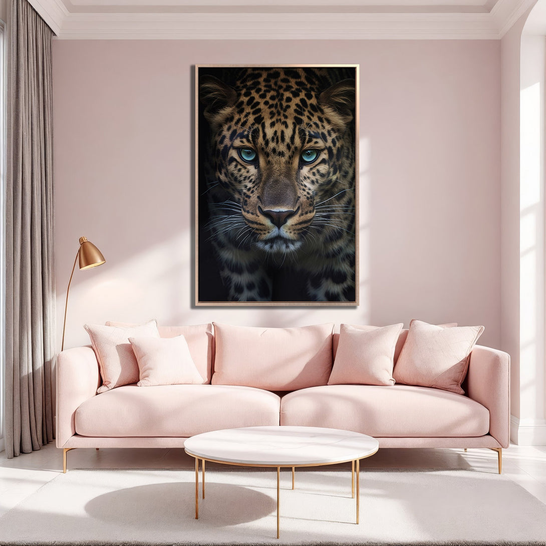 Framed Wall Art: Stunning leopard portrait with striking blue eyes. Modern canvas print in a blush and gold interior, creating a chic and elegant aesthetic.