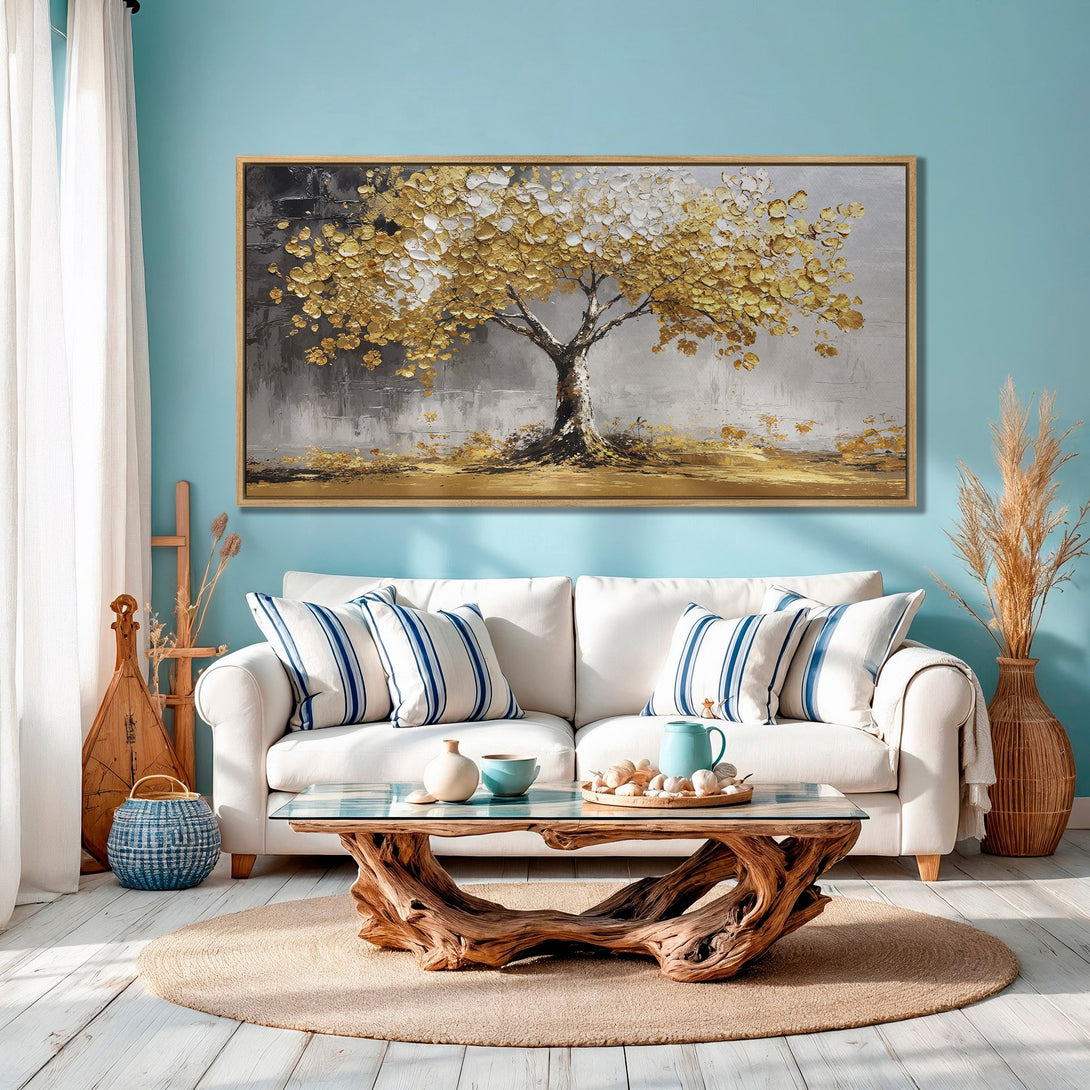 Framed Wall Art: Stunning gold leaf tree painting in a modern style, displayed in a cozy living room with a calming blue and neutral color palette.