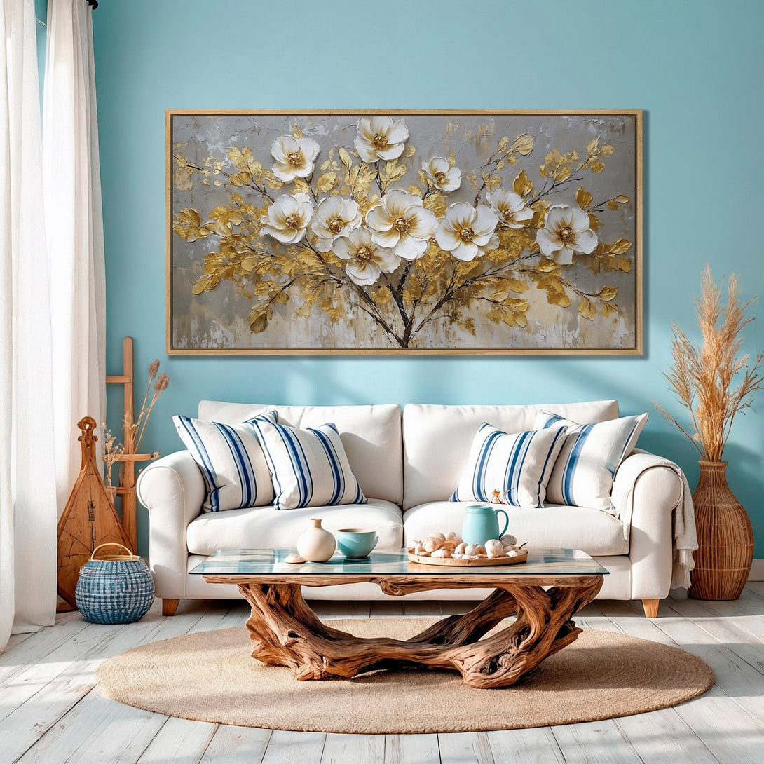 Framed Wall Art: Elegant floral canvas print in gold and white, displayed in a modern living room with a blue and neutral color palette.