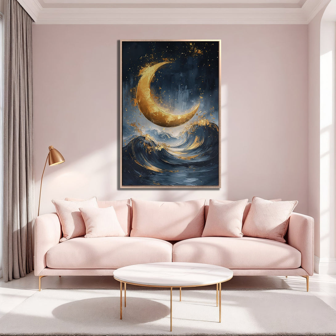 Framed Wall Art featuring a golden moon over ocean waves, displayed in a modern living room with a pink and gold color palette, perfect for adding elegance.