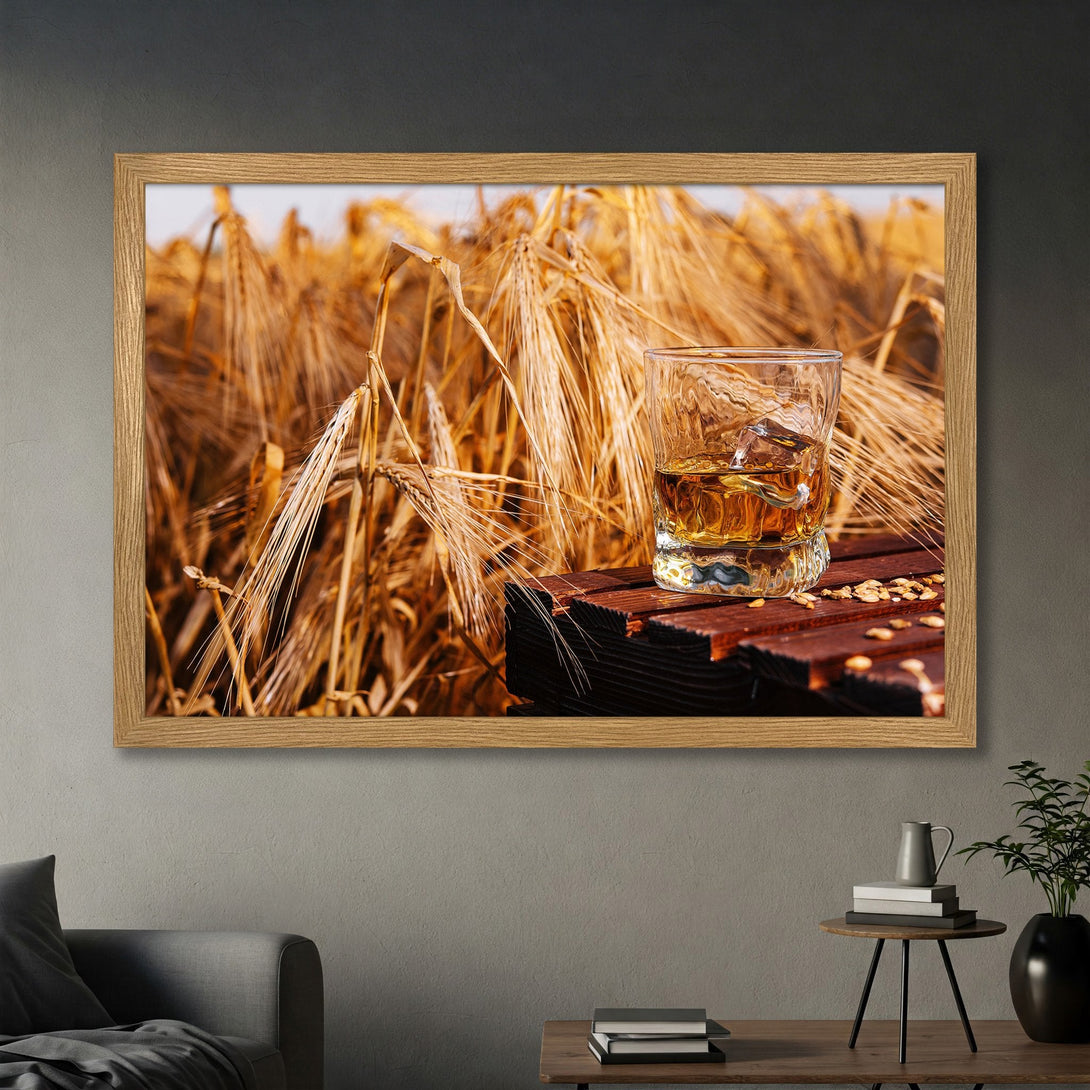Framed Poster featuring whiskey glass on a wooden surface with a wheat field background. Warm, earthy tones create a cozy, rustic style.