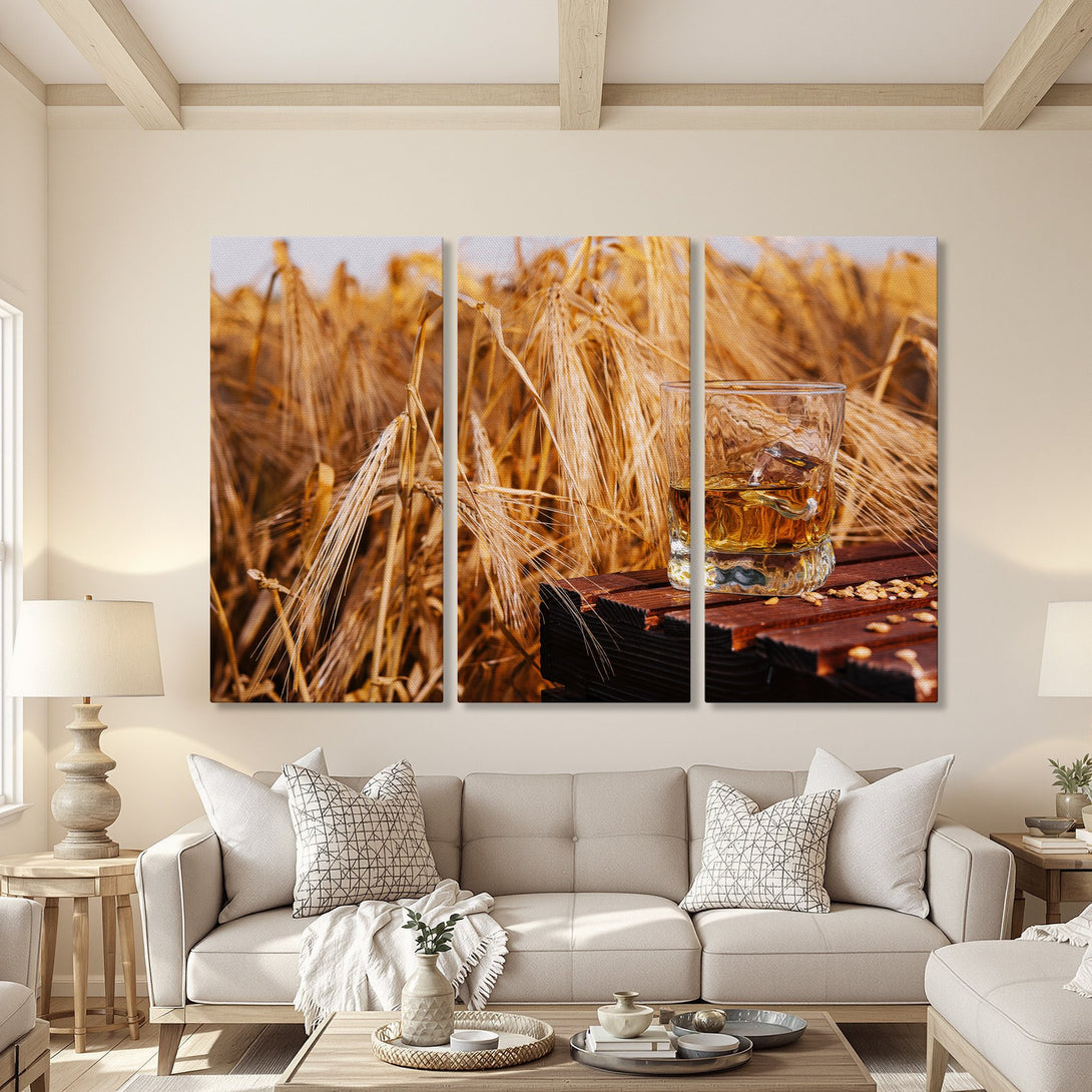 Canvas Print of whiskey on a wooden table in a wheat field, warm tones. Rustic wall art perfect for any home decor.