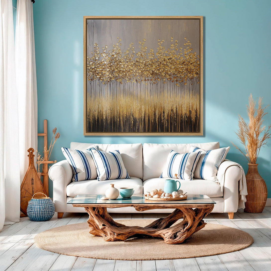 Framed Wall Art: Abstract gold leaf painting in a modern living room. Neutral and gold tones with blue walls create a calming, stylish interior.