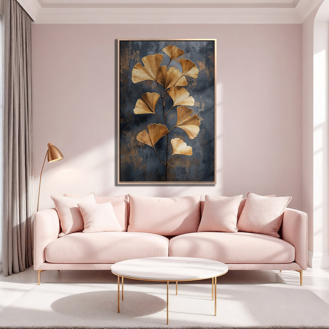 Framed Wall Art featuring gold ginkgo leaves on a dark blue background. Modern art in a blush pink interior. Perfect for adding elegance to your home.