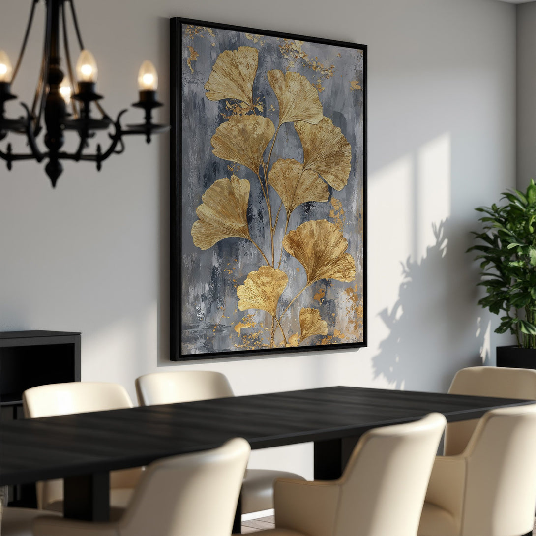 Framed Wall Art featuring gold ginkgo leaves on a gray background. Modern abstract art in a dining room setting. Elevate your space with this elegant piece.
