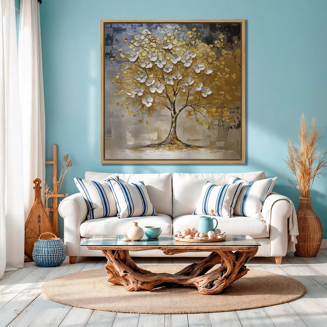 Framed Wall Art: Abstract tree painting in gold, white, and gray tones. Modern canvas art adds elegance to a living room with a coastal color palette.