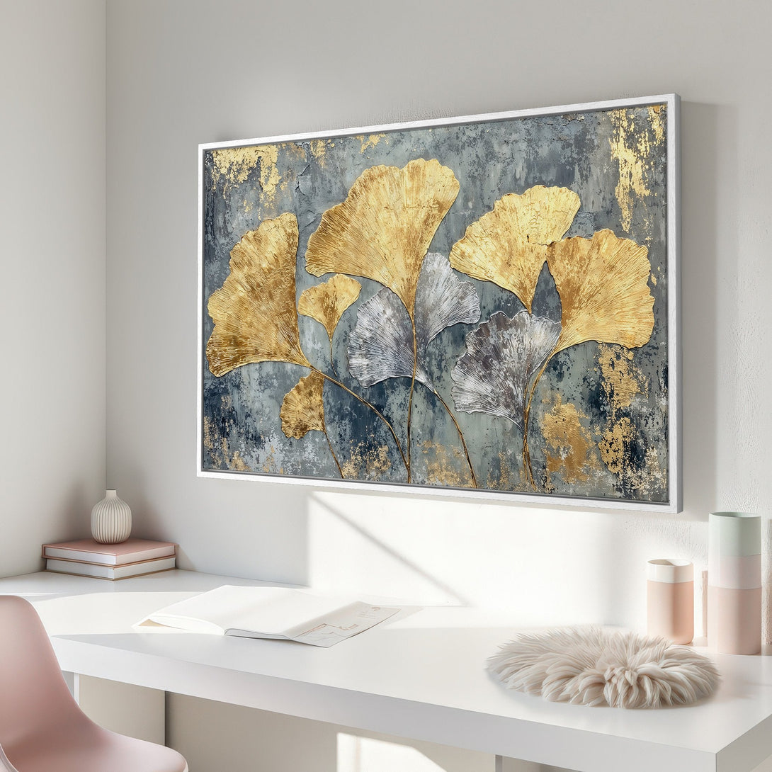 Framed Wall Art featuring gold and silver ginkgo leaves on a textured gray background. Modern abstract art with a luxurious gold and neutral color palette.