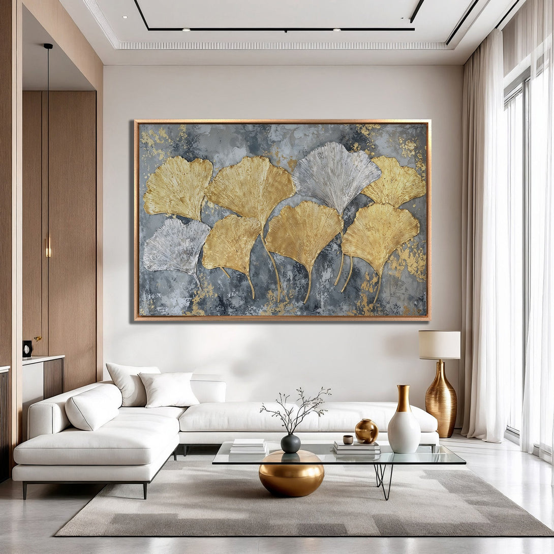 Framed Wall Art featuring gold and silver ginkgo leaves on a textured gray background. Modern abstract art with a luxurious, neutral color palette.