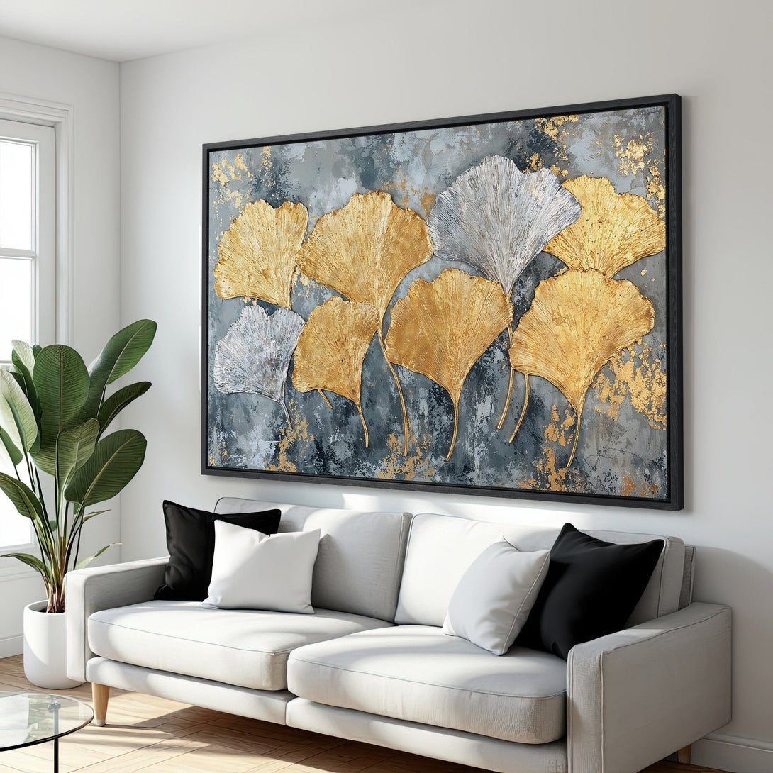 Framed Wall Art featuring gold & silver ginkgo leaves on a textured gray background. Modern, elegant Canvas Print for living room decor.
