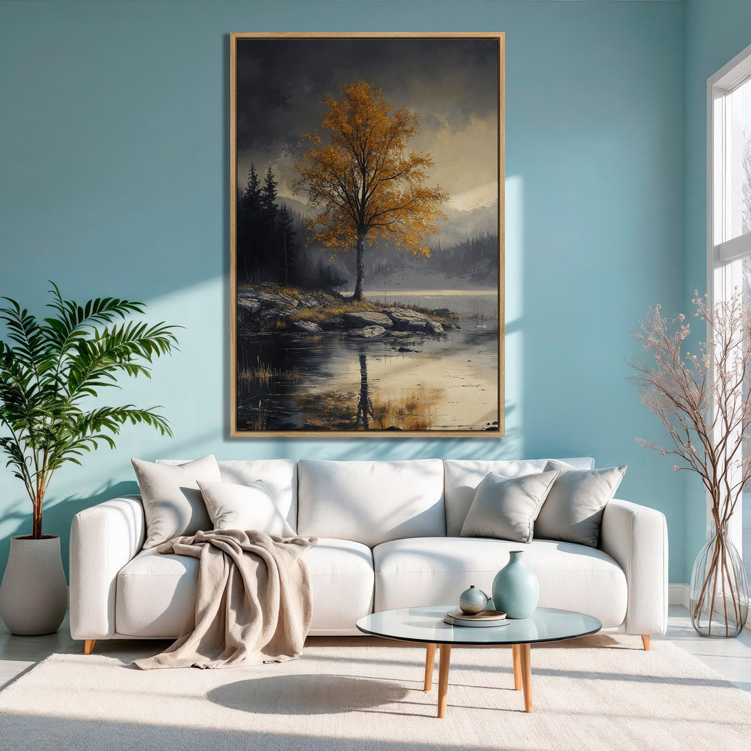 Framed Wall Art: Serene landscape Canvas Print with a golden tree and lake, displayed in a modern living room. Earthy tones and cool blue palette.