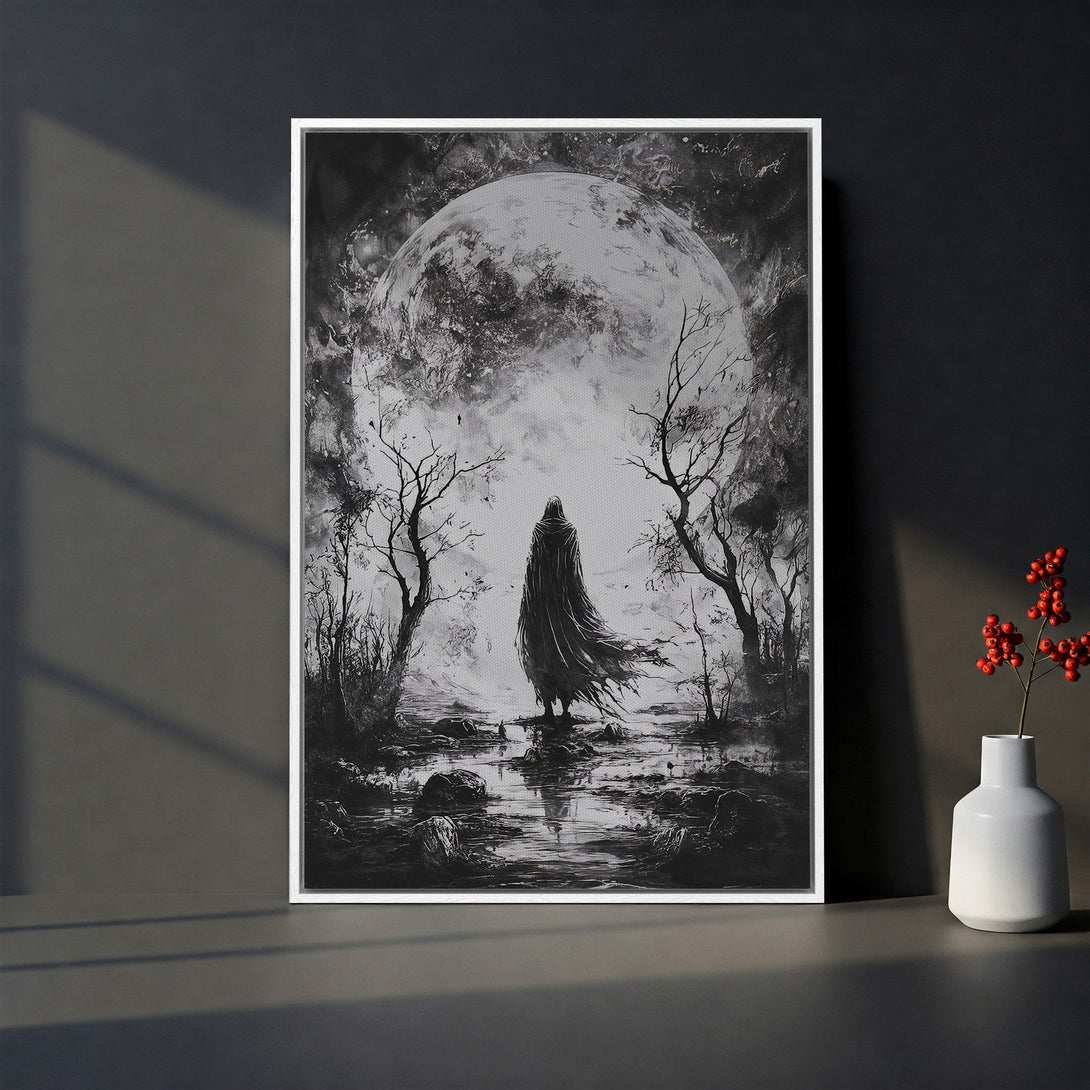 Framed Wall Art: Dramatic black and white canvas print of a cloaked figure before a moonlit scene. Perfect gothic art for your home.