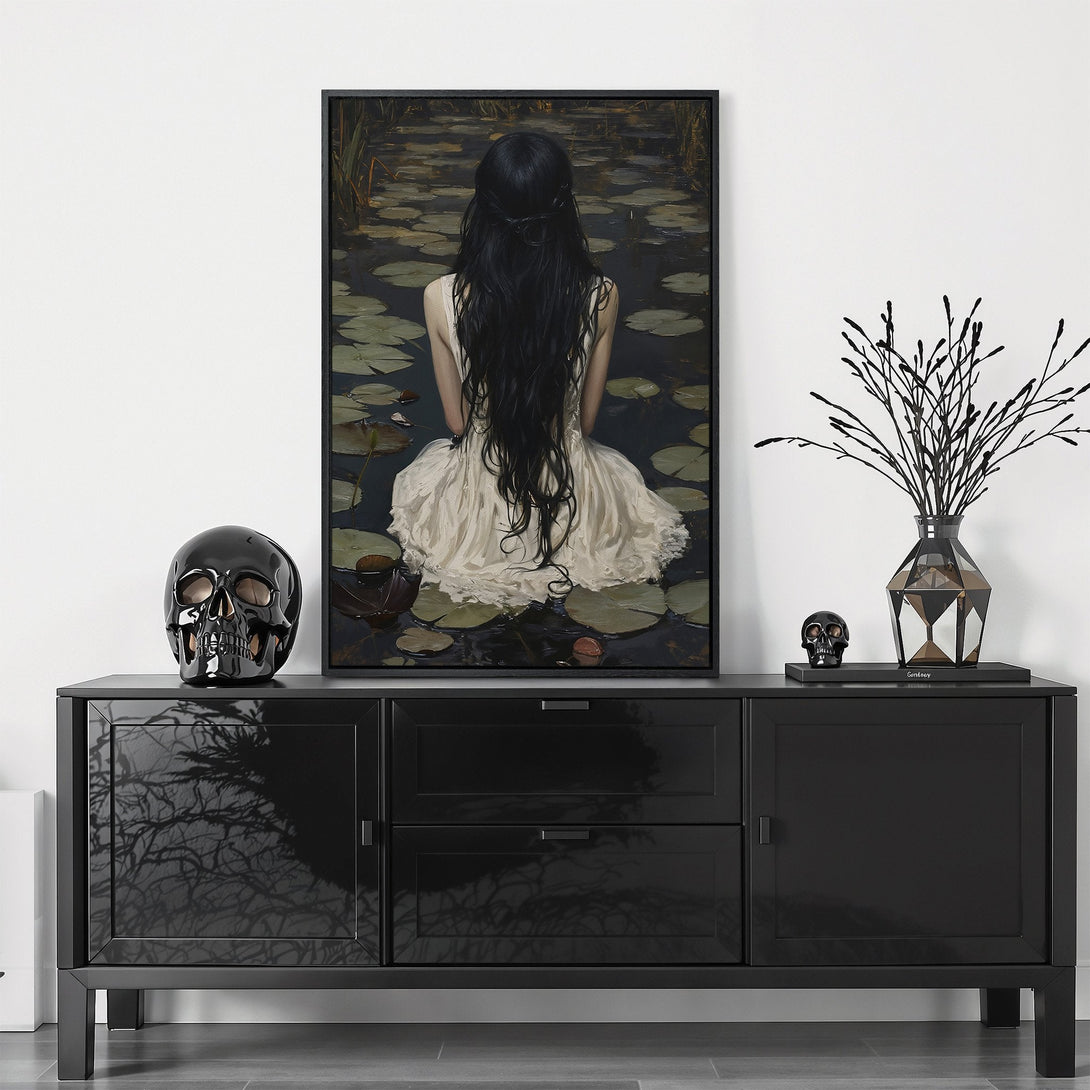 Framed Wall Art featuring a woman in a white dress, dark hair, and a moody, dark color palette. Perfect for adding a touch of elegance and mystery to your space.
